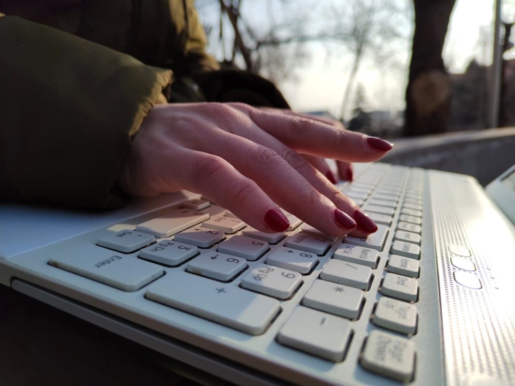 a close up of a person typing on a keyboard