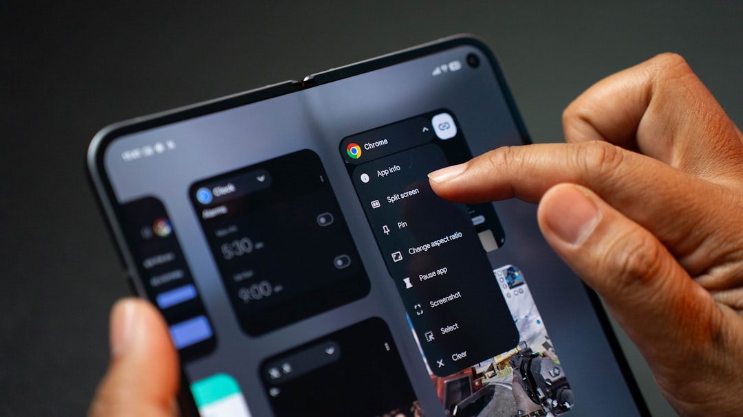 Person using a foldable smartphone with multiple apps open