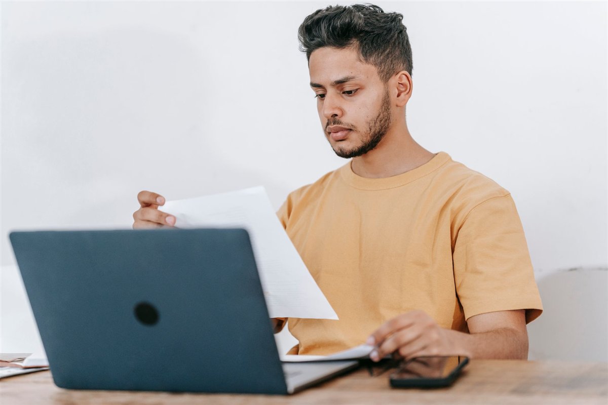 Freelance developer reviewing a project contract on a laptop