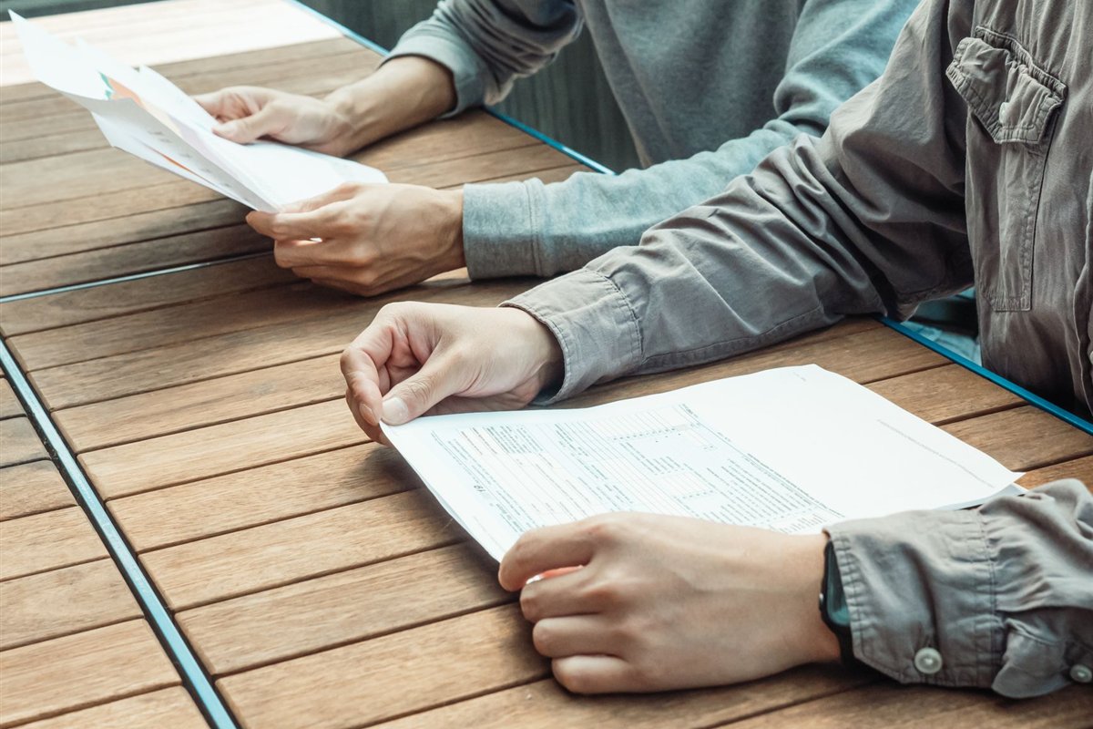Business owner and developer discussing project details at a table
