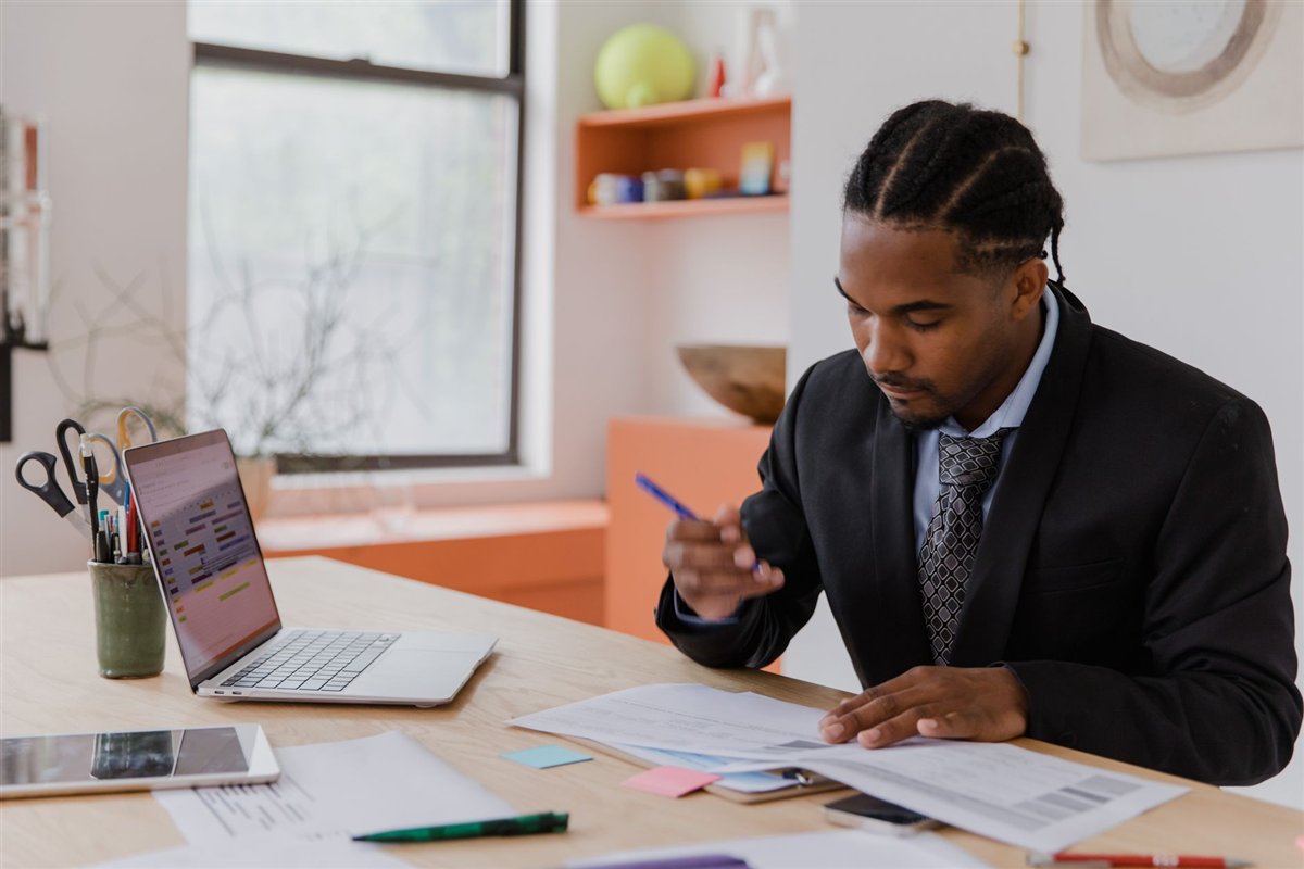 Business owner reviewing website ownership documents at a desk