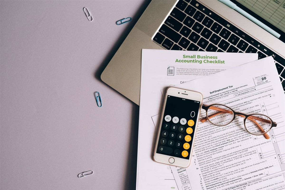 Calculator and notes representing website budget planning
